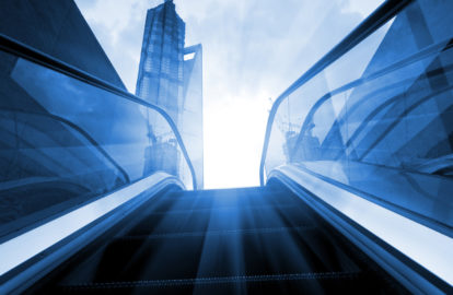 An escalator in a skyscraper frequented by executives and CEOs.