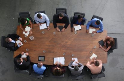 A group of executives sitting around a conference table.